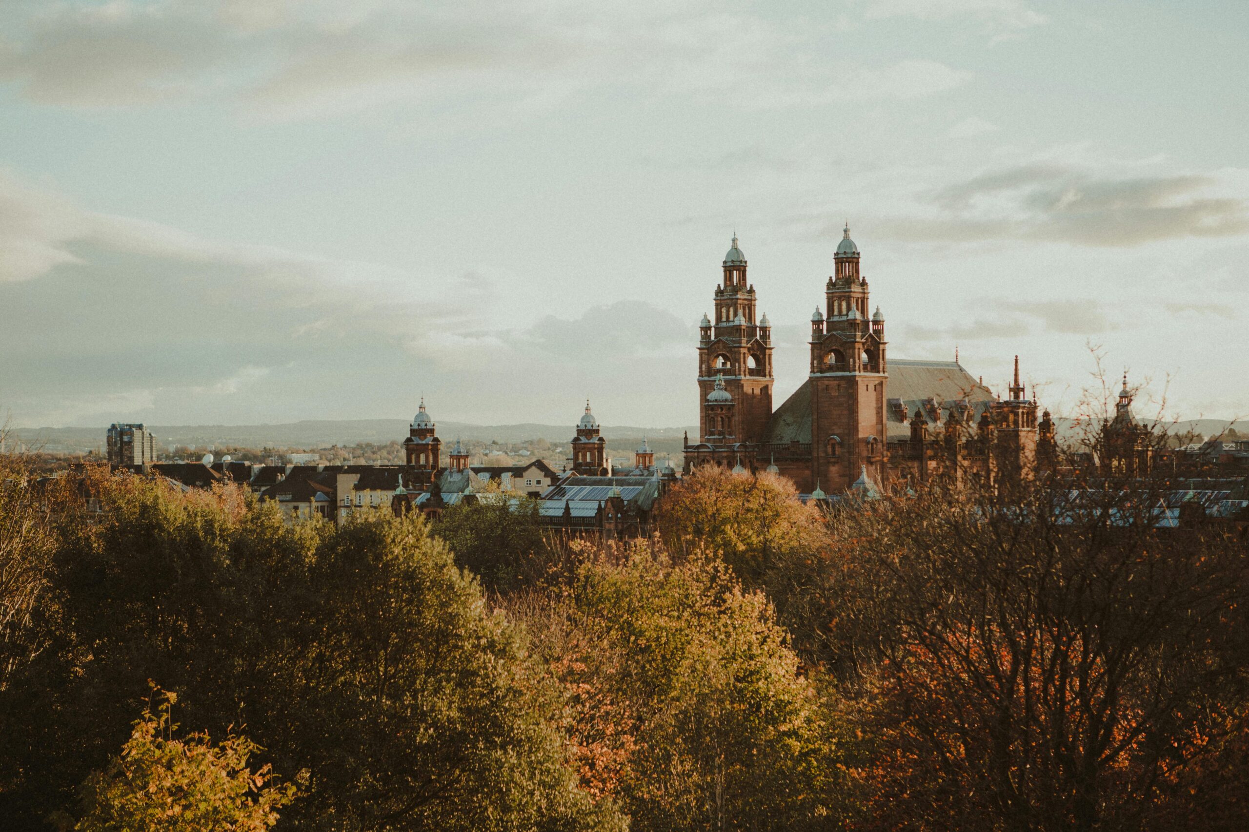 Scenic view of Kelvingrove Museum surrounded by autumn foliage in Glasgow, Scotland.